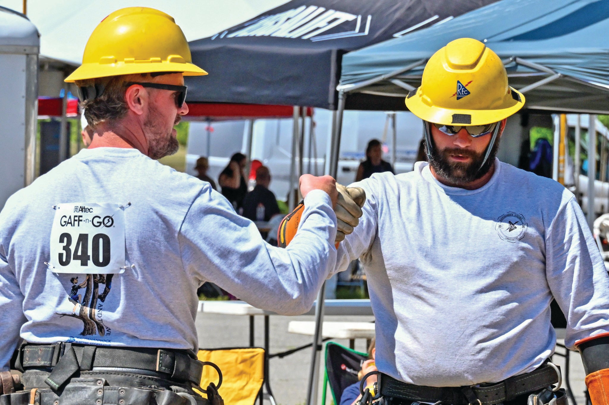 Lineworkers fist bump cover