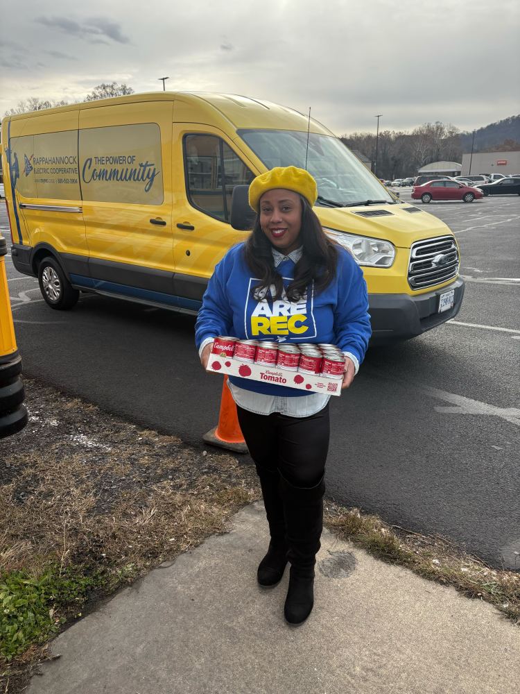 REC brings canned goods to Camping for Hunger in Winchester.