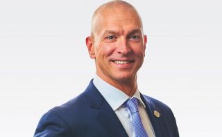 Photo of John Hewa, President & CEO of REC